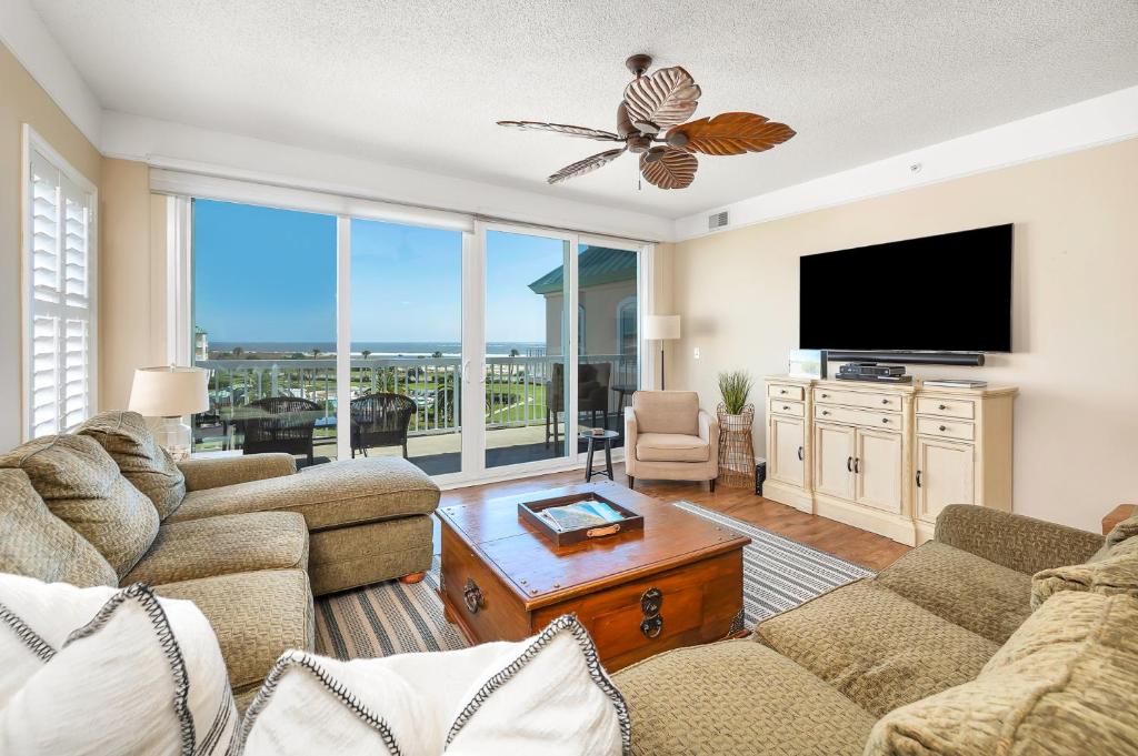 a living room with couches and a flat screen tv at St. Simons Grand # 307 in Saint Simons Island