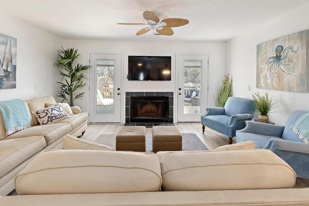 a living room with a couch and a fireplace at Selah in Saint Simons Island