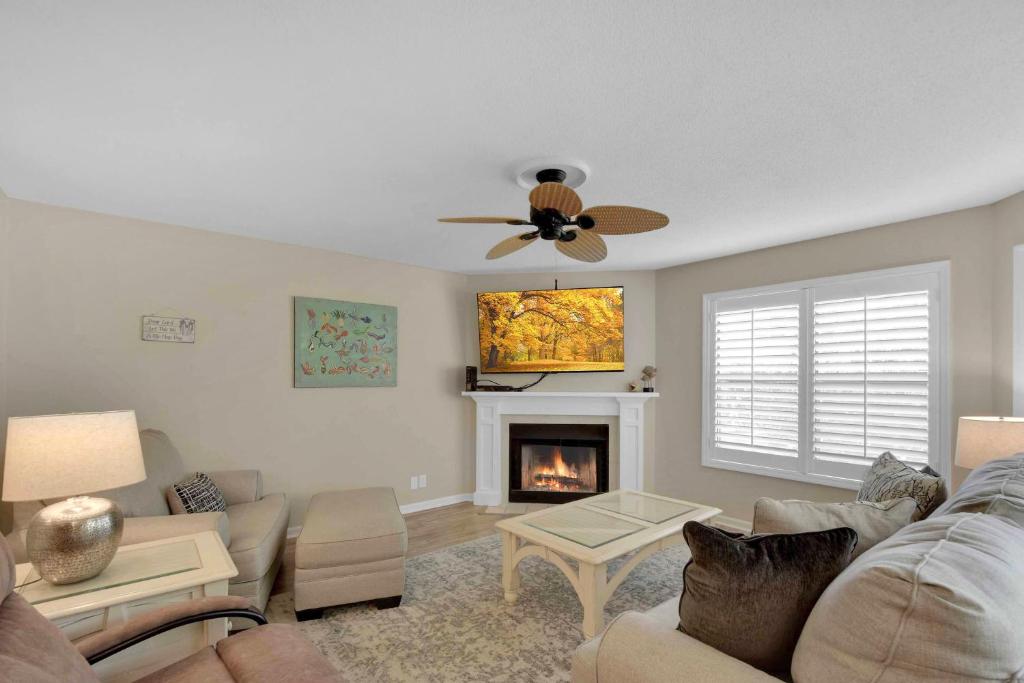 a living room with a couch and a fireplace at Harbour Oaks 311 in Saint Simons Island