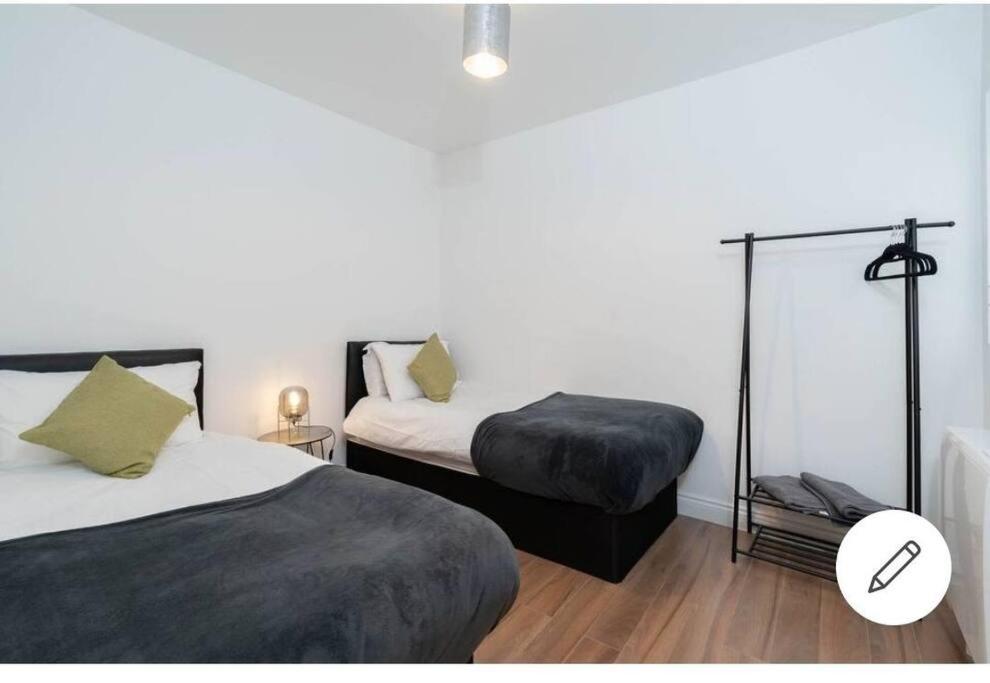 - une chambre avec deux lits et une lampe dans l'établissement Comfy 2 bed Apart /free parking/sleeps 4- Oldbury, à Oldbury