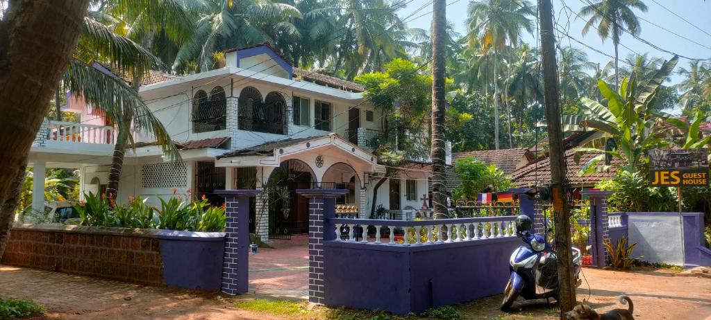 a house with a scooter parked in front of it at Jes Guest House in Majorda