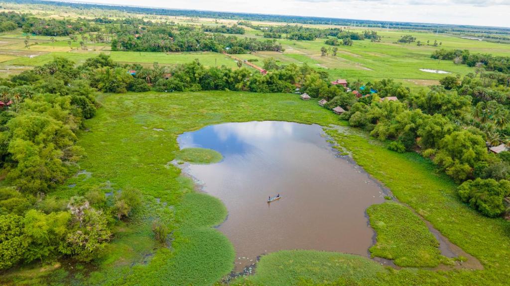 an aerial view of a lake with a boat in it at Khmer Village Homestay 