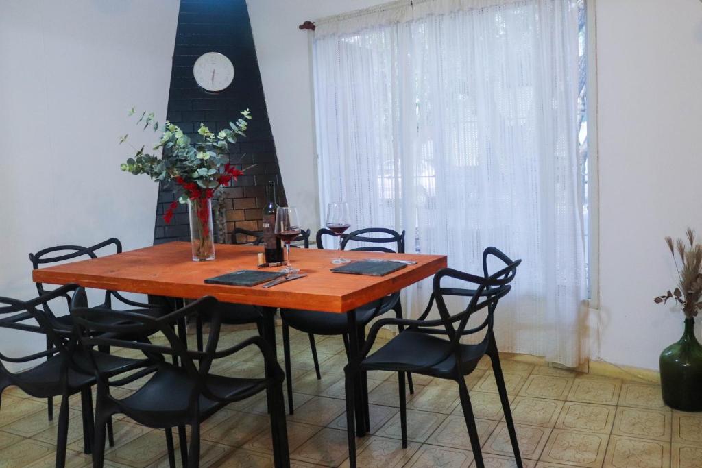 a dining room table with chairs and a wooden table at LA CASA DE LA NONA in Guaymallen