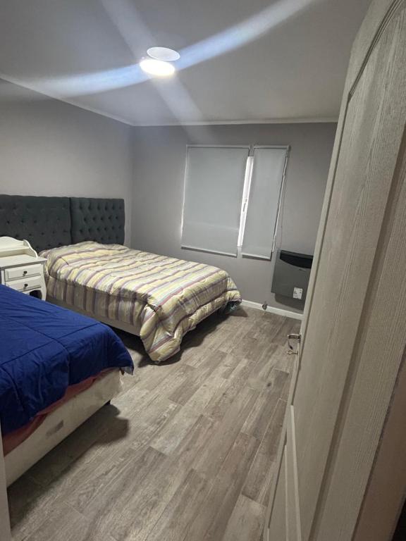 a bedroom with two beds and a television in it at Casa Náutico con estacionamiento privado in Río Gallegos