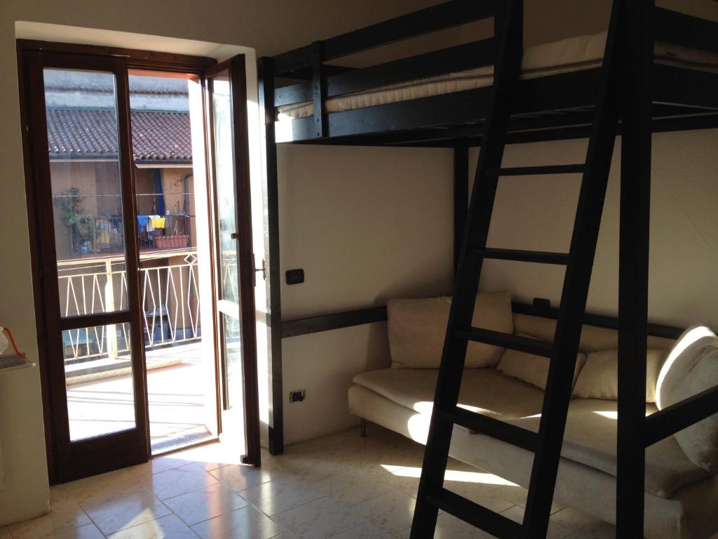 a room with a bunk bed and a balcony at BeB Orio in Capriate San Gervasio