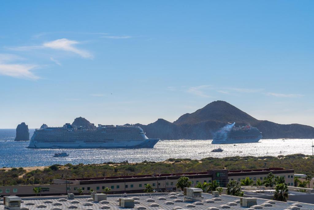 two cruise ships in the water with mountains in the background at Lumina at Vista Velas II Los Cabos in El Pueblito