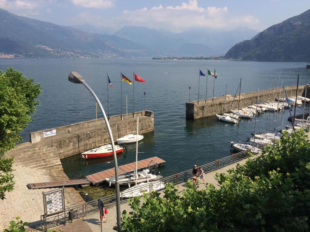 a group of boats docked at a dock on a lake at Apartment Laghée in Bellano