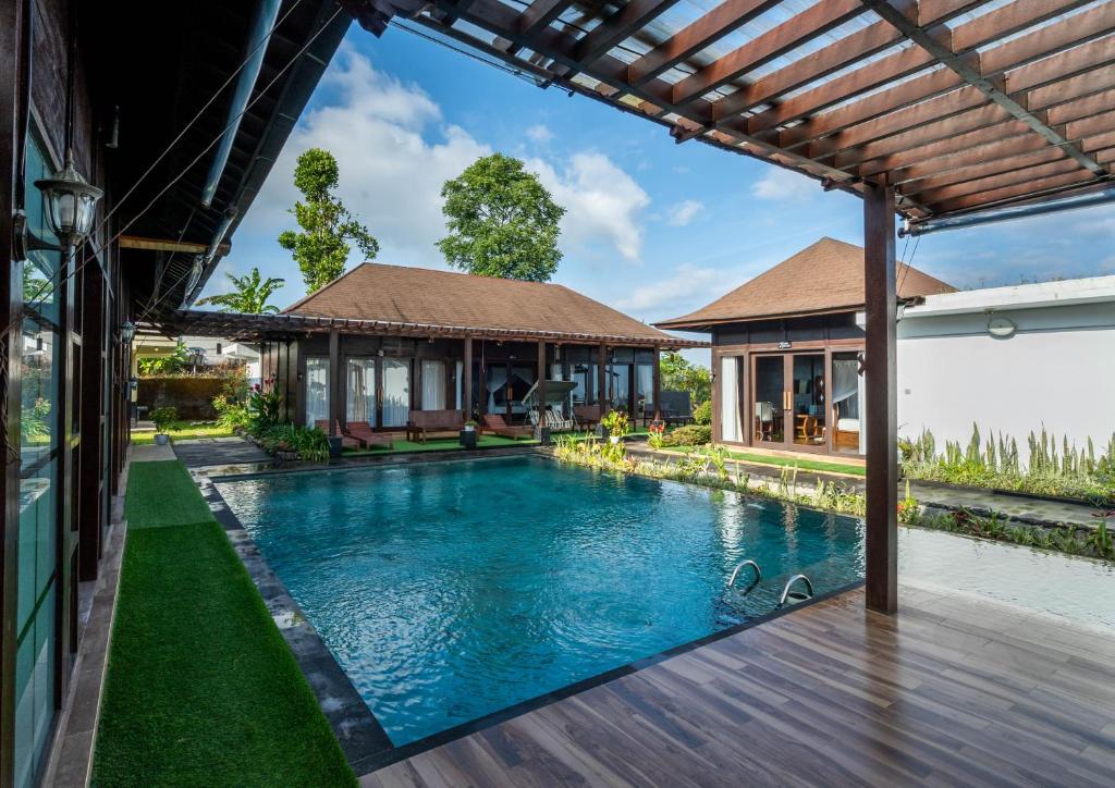 an image of a swimming pool in front of a house at Shankara Munduk Bali in Munduk