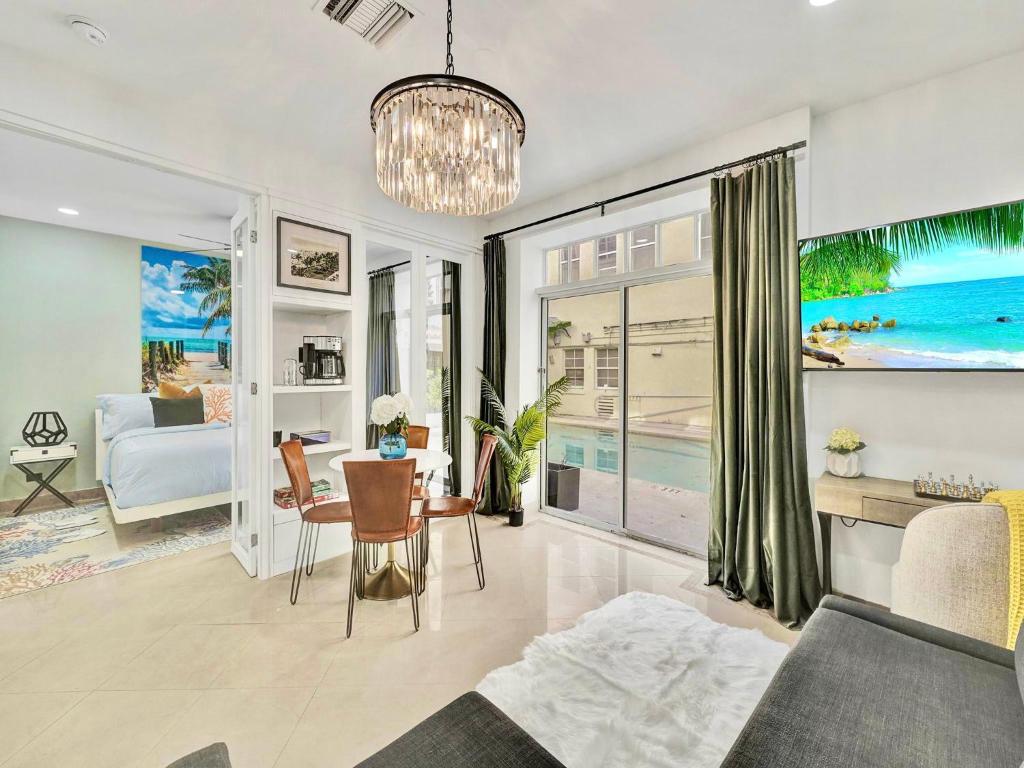 a living room with a bed and a dining room at Park Place South of Fifth in Miami Beach