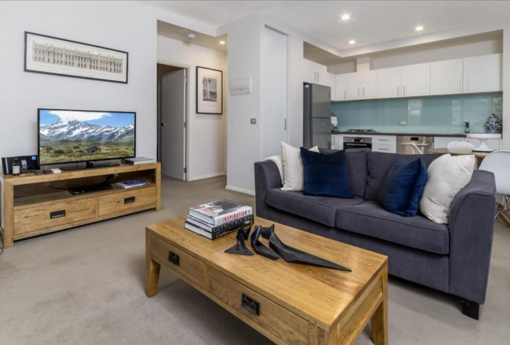 a living room with a couch and a coffee table at Domain 27 Apartment - Barton in Kingston 