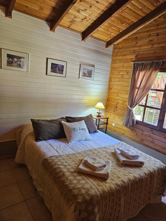 a bedroom with a large bed with two towels on it at Alerce Bariloche in San Carlos de Bariloche