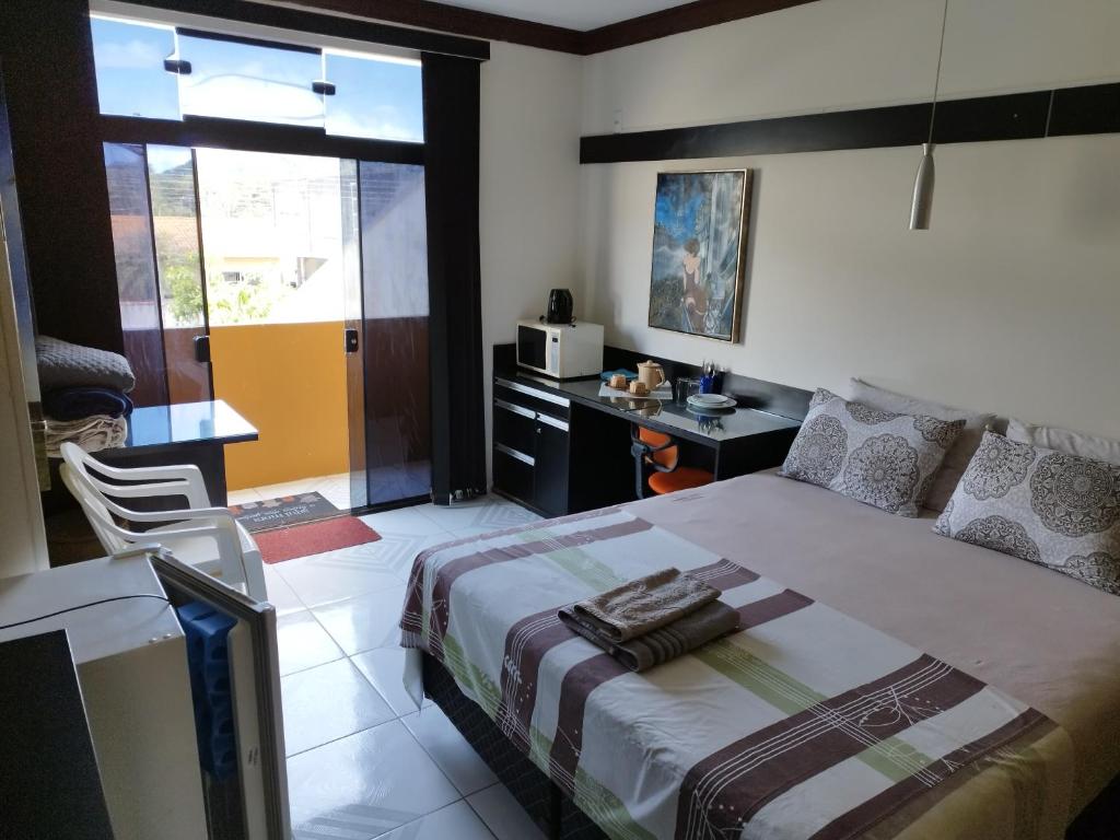 1 dormitorio con cama y escritorio. en Pousada Interpraias, en Balneário Camboriú