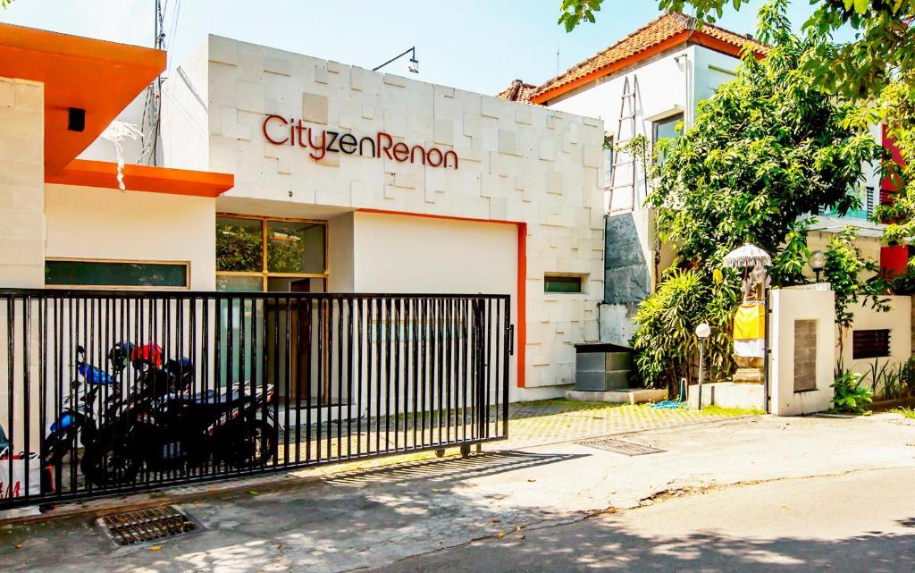 a building with a motorcycle parked in front of it at Cityzen Renon Hotel in Denpasar