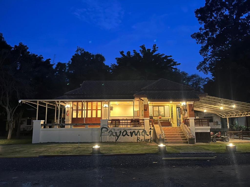 a house with lights in front of it at night at Payamai Resort in Ban Nong Nam Khan