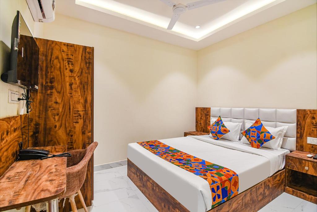 a bedroom with a bed and a wooden wall at FabHotel The Hastings Club in Kolkata