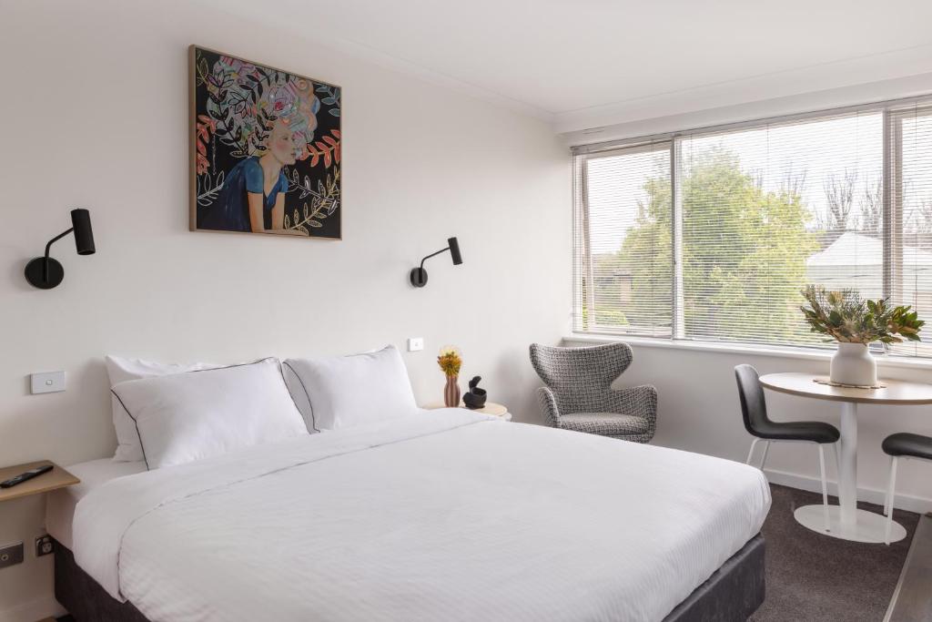 a bedroom with a large white bed and a window at MAC St Kilda by Melbourne Apartment Collection in Melbourne