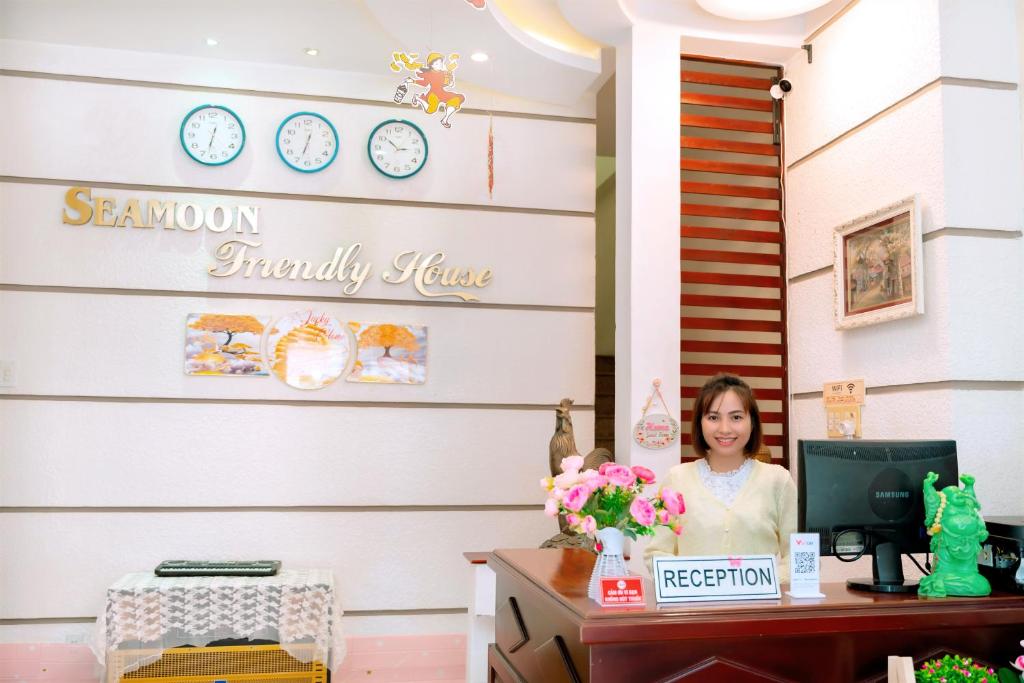 a woman sitting at a desk with a computer at LUCKY HOME in Nha Trang