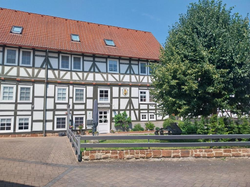 a large building with a tree in front of it at Ferienwohnung "Zum Alten Römer" in Kleinern