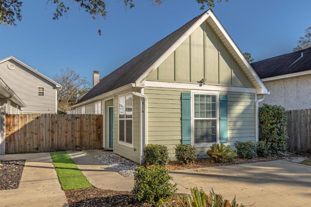 a house with a fence in front of it at Island Retreat in Glynn Haven in Saint Simons Island