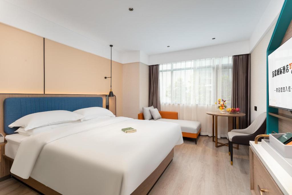 Postel nebo postele na pokoji v ubytování Guangzhou Yilin Hotel - Xiaogang metro Store