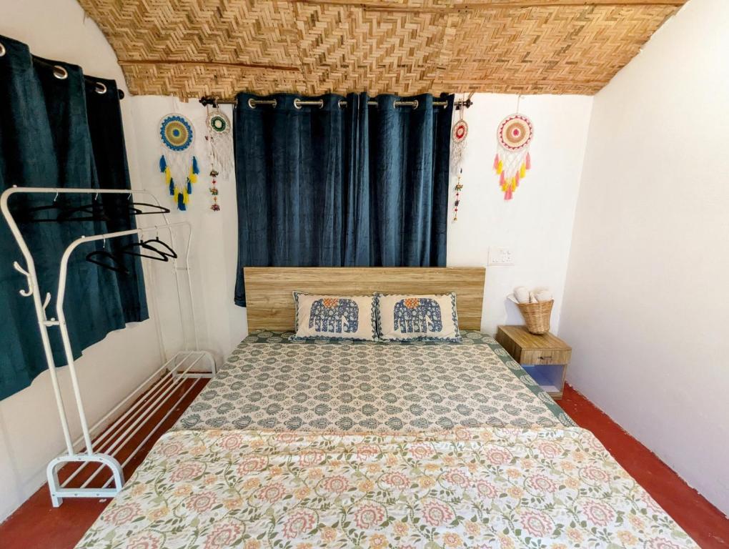a bedroom with a bed with blue curtains at Cozy Wellness Cocoons in Mandrem