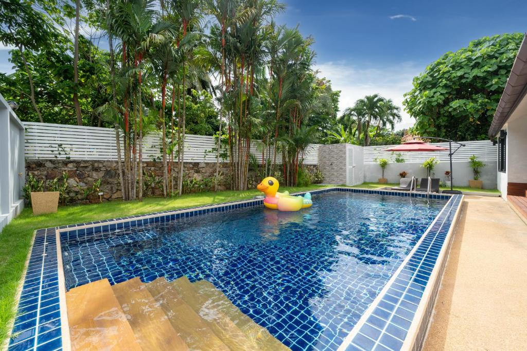 a swimming pool with a rubber duck in a backyard at Sanook Villas -Geng Mak Nai Harn in Rawai Beach