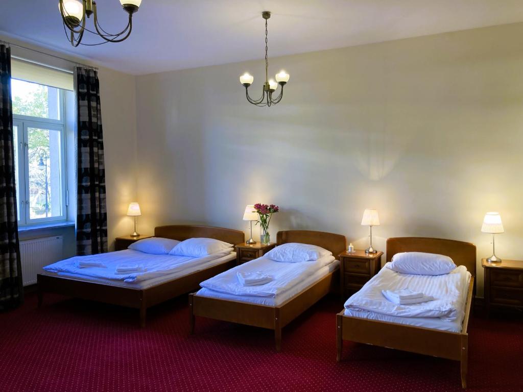 Posteľ alebo postele v izbe v ubytovaní Hotel Łazienkowski