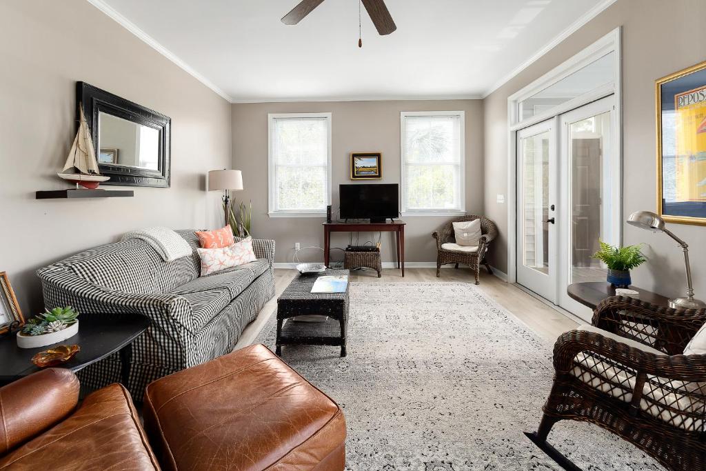 a living room with a couch and a tv at 221 Olive Way in Saint Simons Island