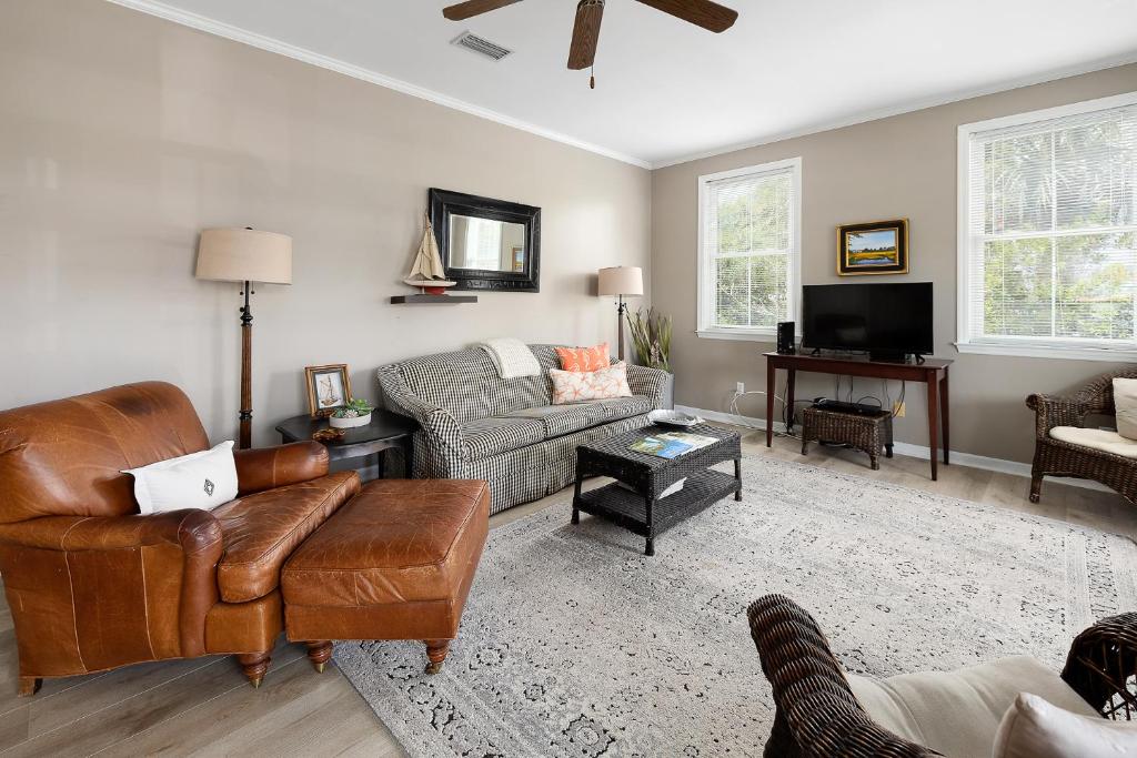 a living room with a couch and a chair at 221 Olive Way in Saint Simons Island