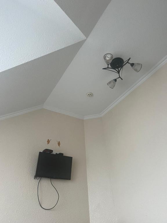 a room with a ceiling with a fan and a shelf at Апартамент 2-х комнатный in Făleşti