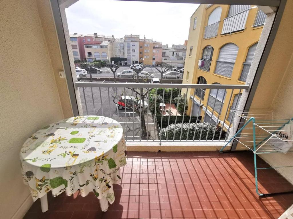 un balcon avec une table et une vue sur une ville dans l'établissement 085 Cap city C27, au Cap d'Agde