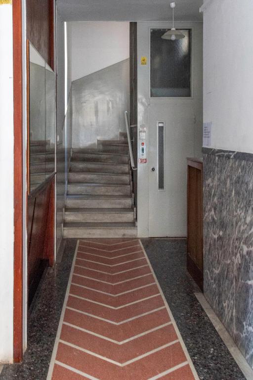 an empty hallway with stairs and a stair case at Alkea Thessaloniki in Thessaloniki