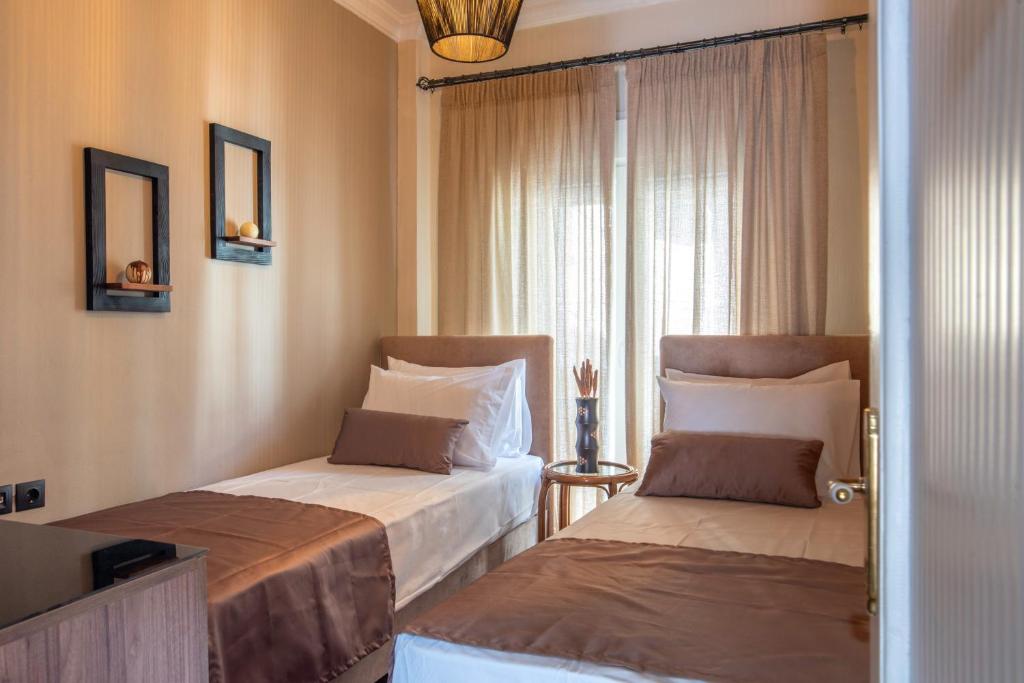 a hotel room with two beds and a window at Alkea Thessaloniki in Thessaloniki