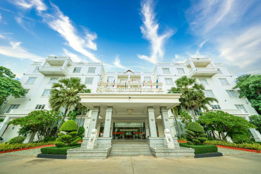 a white building with a balcony on top of it at Pursat Riverside Hotel & Spa in Pursat