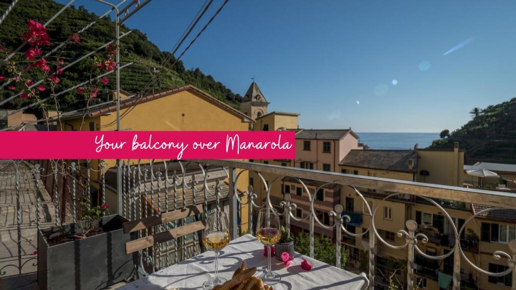 - un balcon avec une table et des verres à vin dans l'établissement Liersena Sea View Mini Villa with AC, à Manarola