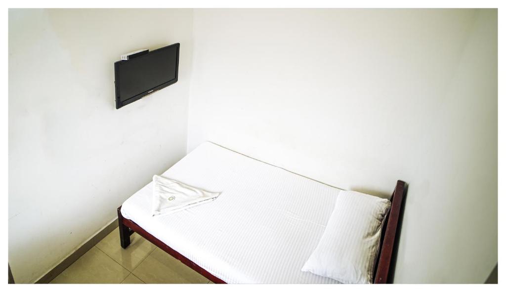 Postel nebo postele na pokoji v ubytování Kay Kay Residency