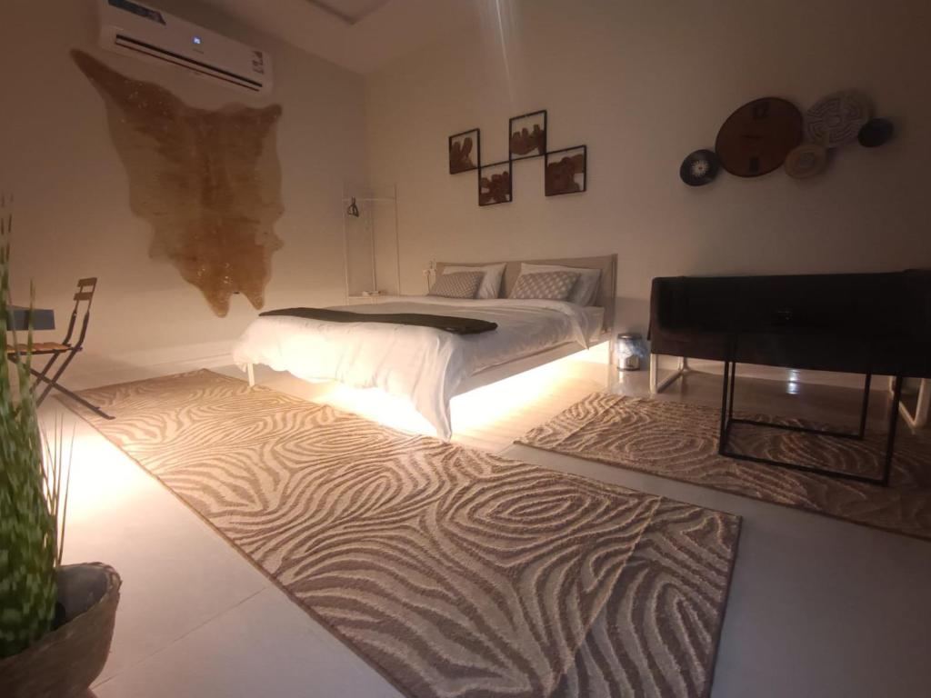 a bedroom with a bed with a zebra rug at بوهيمي هومتيل Bohemia Hometel in Al ‘Azīzīyah