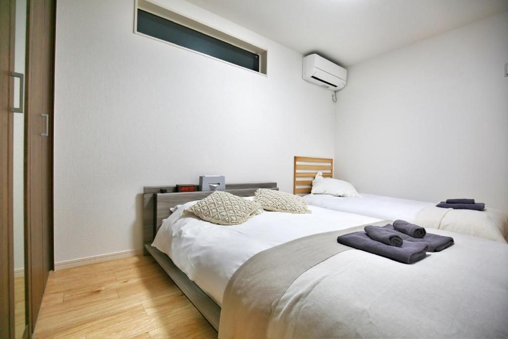 Postel nebo postele na pokoji v ubytování kameido k hotel
