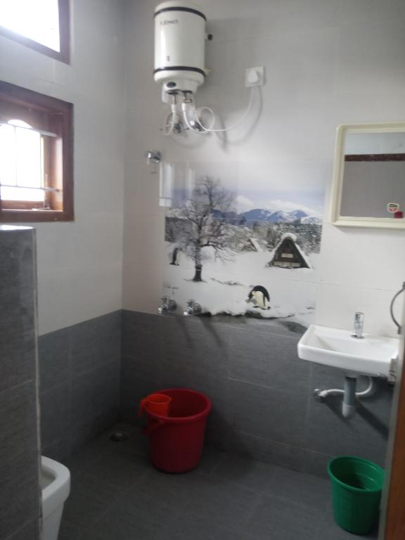 a bathroom with a toilet and a sink at Sai Trishuul home stay in Ooty