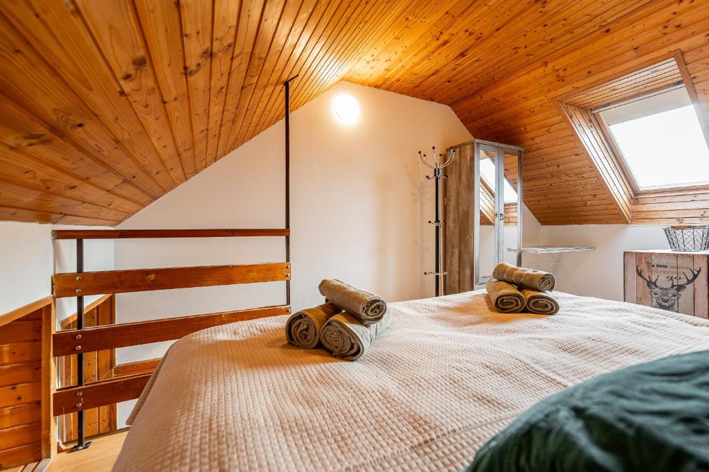 a bedroom with a bed with wooden ceiling at Apartmán Mezonet na Námestí Košice in Košice