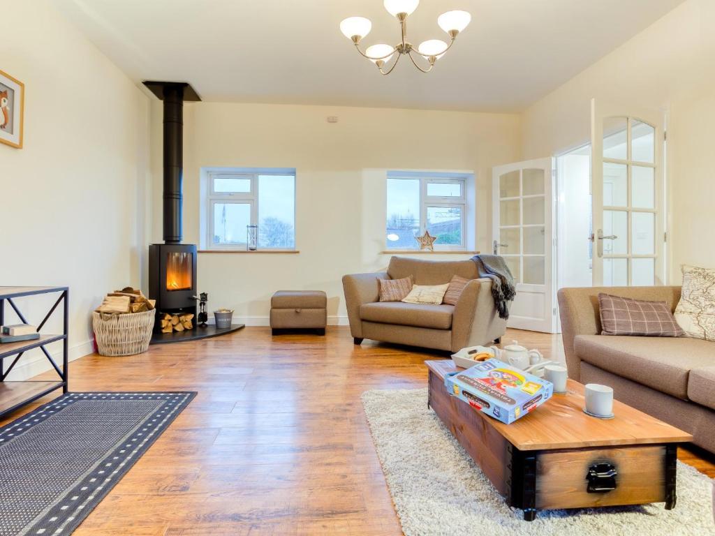 a living room with a couch and a table at 4 Bed in Parkham 76452 in Parkham