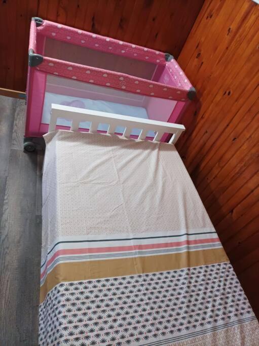 a pink toy bed sitting on the floor at Villa Imelda à saint André la réunion in Le Patelin