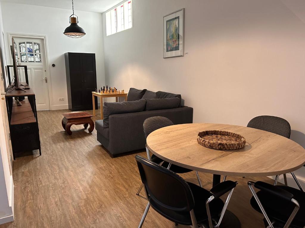 a living room with a table and a couch at Artistic apartment, City Centre Dordrecht in Dordrecht