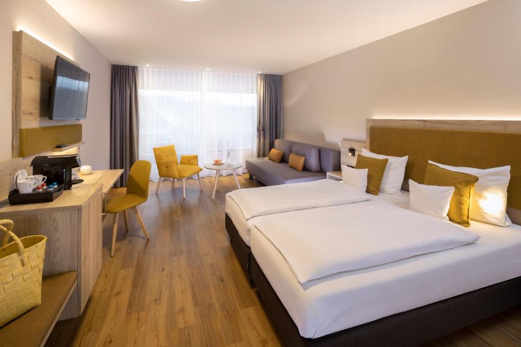 Postel nebo postele na pokoji v ubytování Sonnenhof Hotel & Spa
