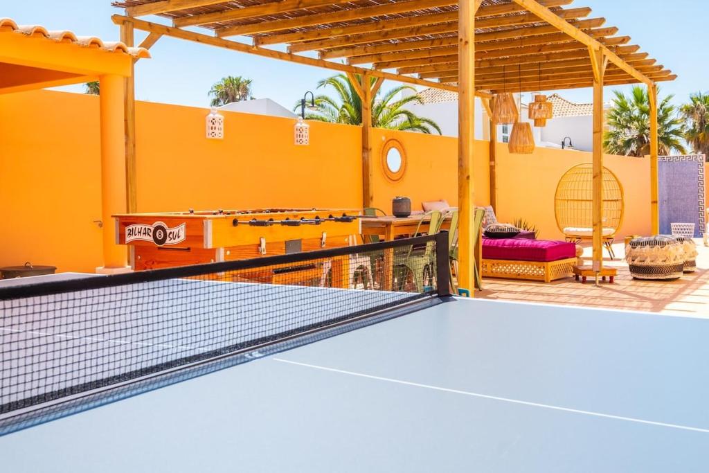 a tennis court with a ping pong racket at Villa alhabu in Albufeira