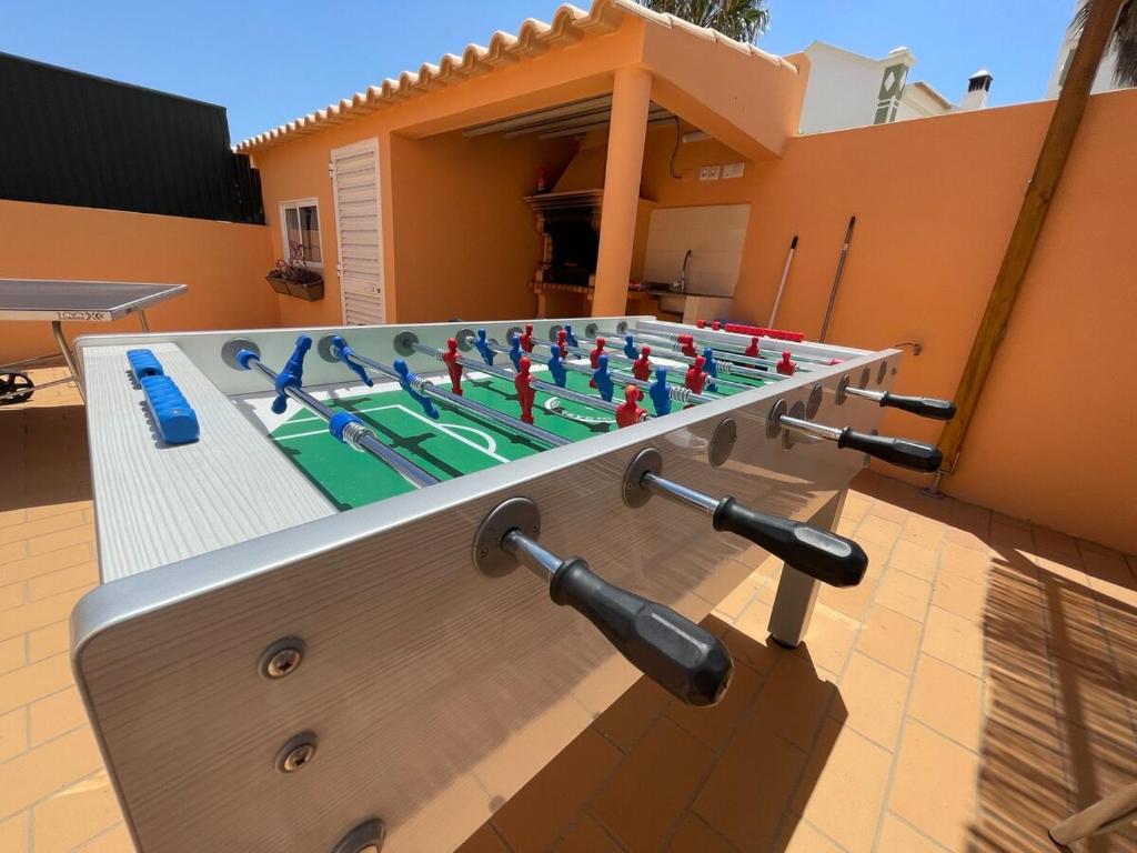 a large pool with a table with a game of chess at Villa alhabu in Albufeira