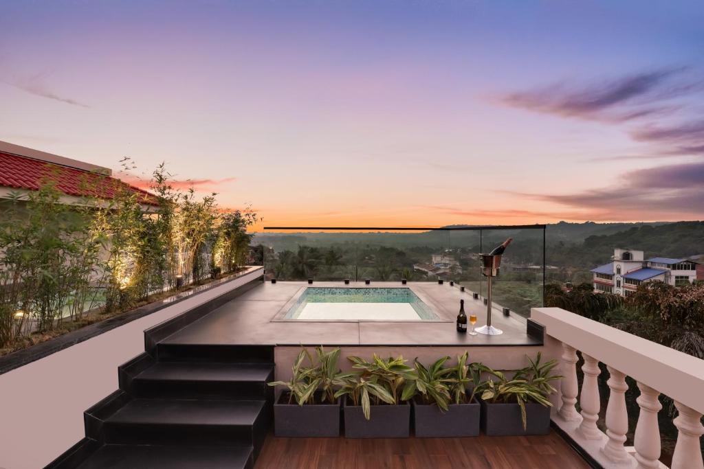 a house with a swimming pool on a balcony at Antarim Resort in Candolim