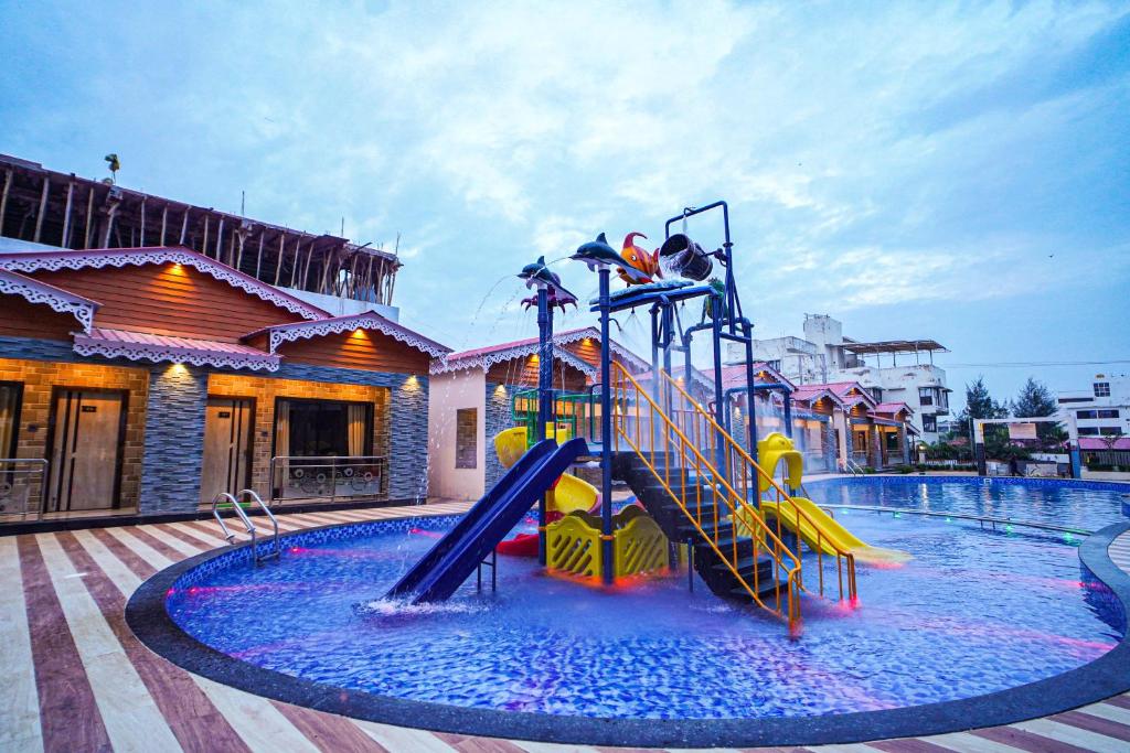 a water park with a slide in a swimming pool at THE RATH INNS in Mandarmoni