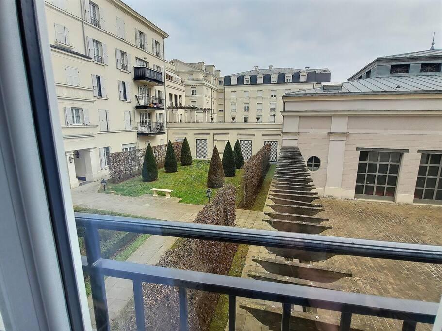 a view of a garden from a window at Le Nuage d&#39;Arianne*Vale d&#39;Europe *Disney*Paris in Chessy