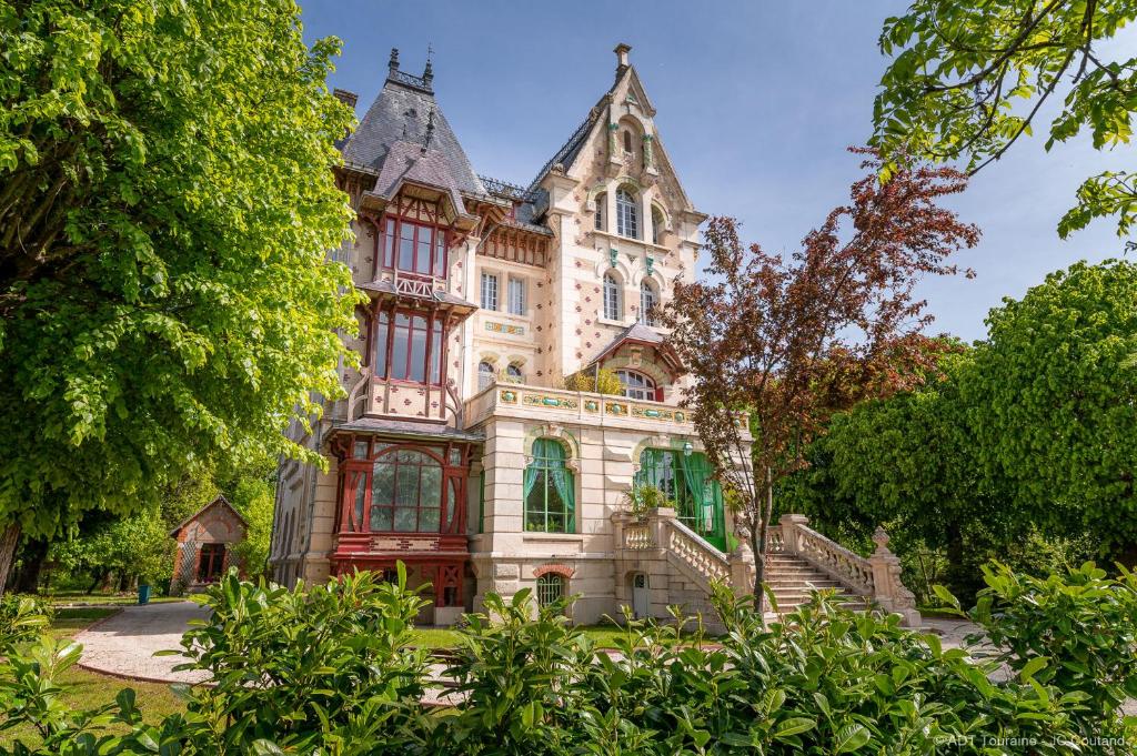 une grande maison avec des escaliers en face de celle-ci dans l'établissement Villa Alecya, à Sainte-Catherine-de-Fierbois